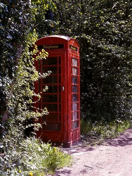 Old style telephone box in a quiet country village road