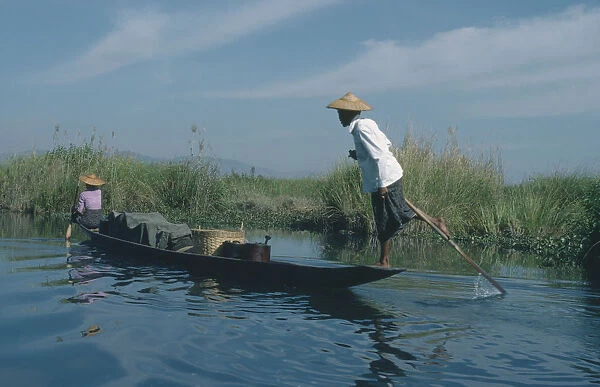 20066284. MYANMAR Transport Fishing boat rowed by oarsman using one leg. Burma