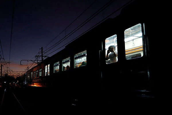 A child looks out from a train carriage in Jakarta