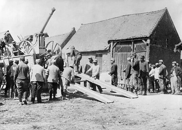 WWI: ARMORED CAR, c1915. Soldiers unloading an armored car in a village. Photograph