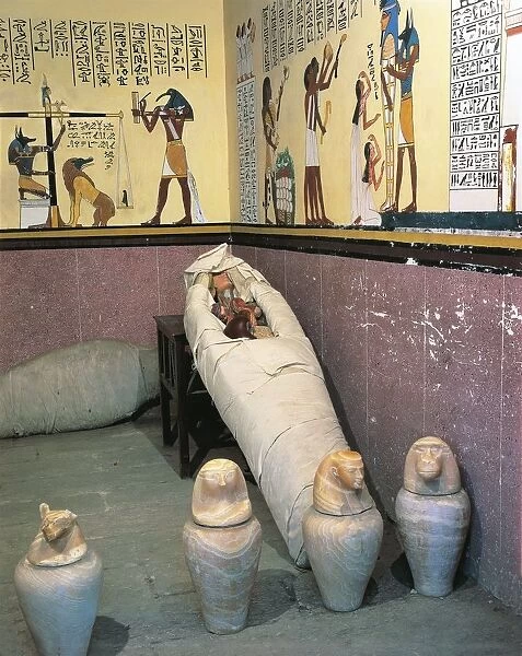 Replica of mummy chamber with four canopic jars containing viscera of deceased; liver, stomach, lungs and intestines with lids representing heads of Amset, Hapi, Qebehsenuef and Duamutef