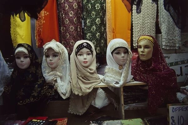 Singpore, Singapore City, Geylang Serai, Geylang Serai Market, traditional headscarves displayed on model heads