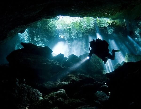 Cenote diver enters Taj mahal cavern on Yucatan peninsula in Mexico