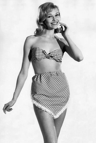 Woman wearing a check patterned bikini with unusual pants June 1962 P011070