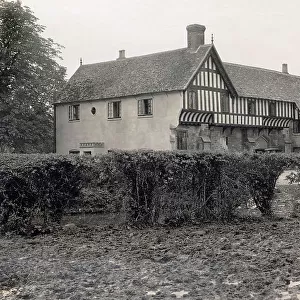 Brockworth Court (16th century Tudor manor house) and St George's Church tower, in the village of Brockworth, Gloucestershire Date: 1930s