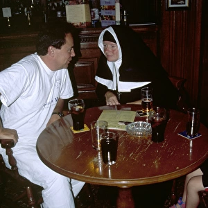 Nun with a man in a pub