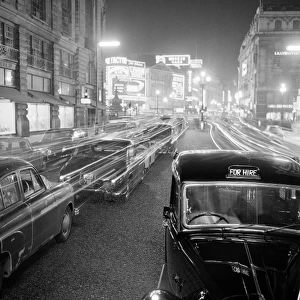 Stationary traffic along a busy Piccadilly at night
