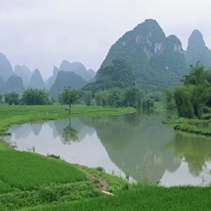 Reflections in water and the distinctive karst limestone landscape typical of the region south of Guilin, Guangxi, Yangshuo