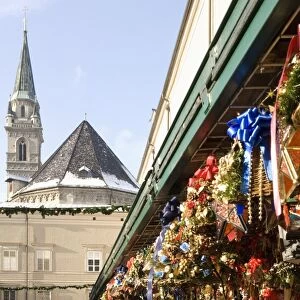 Stall selling Christmas decorations with towers of Franziskanerkirche churchbehind