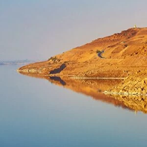 Barren shoreline and salt water of the Dead Sea, Jordan