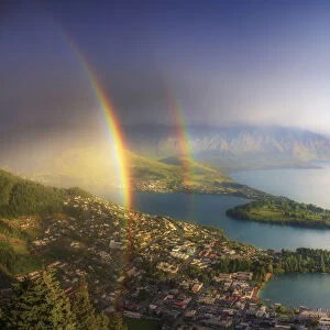 Elevated view of Queenstown and Wakatipu lake with a double rainbow, South Island