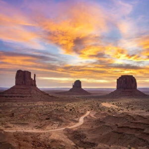 The Mittens against colourful cloudy sky at sunrise, Monument Valley, Arizona, USA