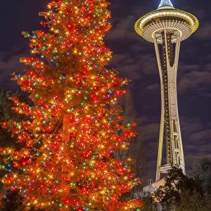Night view of Space Needle and Christmas tree at Seattle Center, Seattle, Washington, USA