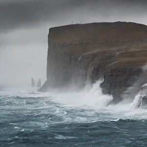 one sea storm hits the Risin og Kellingin cliffs during an autumn day, Eysturoy, Faroe Islands, Denmark