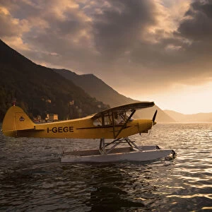 A seaplane on Como Lake at sunset. Lombardia. Italy