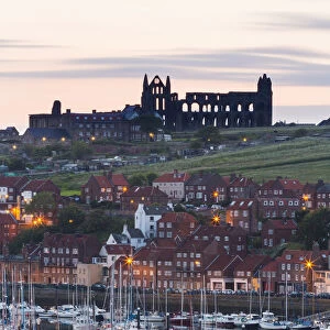 United Kingdom, England, North Yorkshire, Whitby. The Abbey and harbour before sunrise