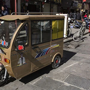 A tiny enclosed auto rickshaw in Lhasa, Tibet