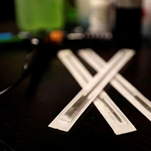Stainless steel needles lie on a desk in a tattoo studio in Prague