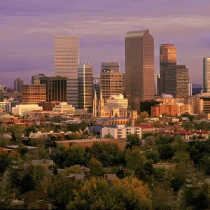 Denver, Colorado skyline glistens in early morning during sunrise against the Rocky