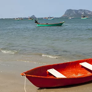 Thailand, Prachuap Khiri Khan. Ao Manao beach. Small colorful rowboats pulled up on the beach
