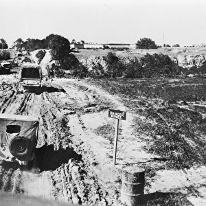 WORLD WAR II: LIBYA. U. S. Army Jeeps driving past an area containing enemy mines