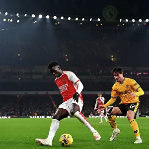 Arsenal's Bukayo Saka Faces Off Against Wolverhampton Wanderers Hugo Bueno in 2023-24 Premier League Clash