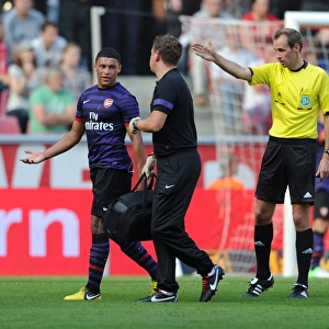 Arsenal's Colin Lewin Tends to Injured Oxlade-Chamberlain in Pre-Season Friendly against Cologne