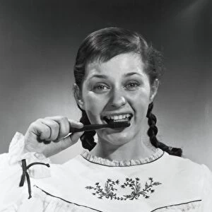 Vintage portrait of a teen girl brushing her teeth
