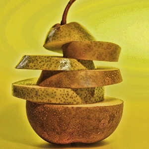 Green and brown sliced pear