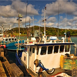 Lobster trawlers tied to the wharf inside Currie harbour, King Island Tasmania