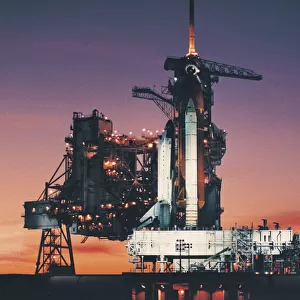 Space Shuttle Columbia on launch pad and the setting sun