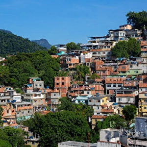 View Of Favelas in Rocinha and Christ The Redeemer At The Top Of Corcovado Mountain, Rio De Janeiro, Brazil, South America