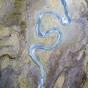 Aerial view of torrent between rocks at foot of mountains, Preda Rossa, Valmasino