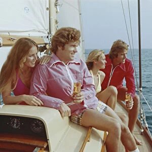 Couples sitting on sailing boat, smiling