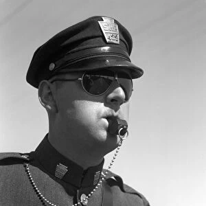 Highway Patrolman In Uniform And Sunglasses Blowing His Whistle Without Use Of His Hands Badge Cap Chain Keystone