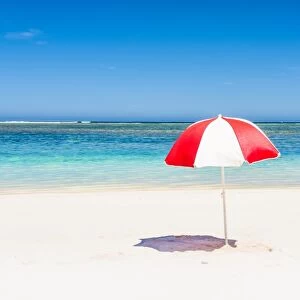A multicolored beach umbrella on the shore. Western Australia