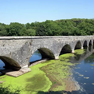 Old eight arch bridge in welsh countryside