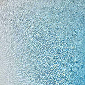 Slightly ruffled turquoise-coloured surface of water in a swimming pool