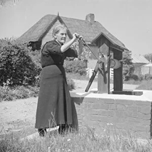 Rebecca Munday using a water well in Deans Bottom, Kent. 1939