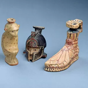 Three east Greek Plastic perfume-pots in the form of a crouching monkey a