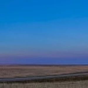 Panoramic view of the rising harvest moon and setting Sun, Alberta, Canada