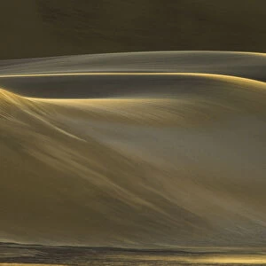 Fine sand dunes smoothed by gentle winds at sunset, in the coastal desert of Dorob