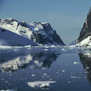 Reflections in Lemaire Channel with brash ice, Antarctica
