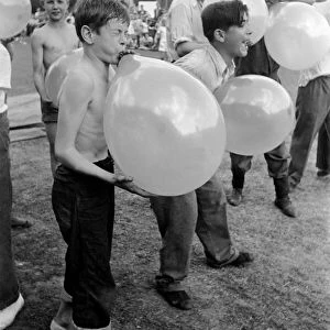 Balloon bursting competition during a childrens sports day. August 1952 C4047