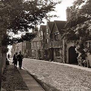 Couple walking down a quiet cobbled road in Rye Sussex
