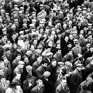 A large crowd of men waiting in the cold in 1962