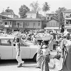 Market traders on Water Street Monrovia, Liberia buying and selling food March 1980