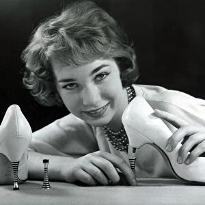 A model showing off a pair of new high heel shoes, which have steel heels that screw