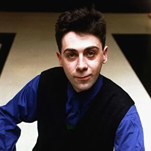 Sean Hughes TV Comedian in Black V neck cardigan and blue shirt and tie A©Mirrorpix