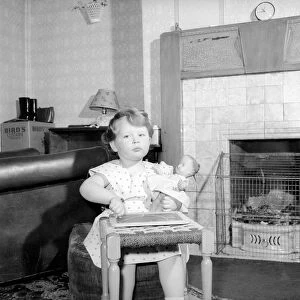 Small girl drawing beside the fireplace: Betty Hampson 36 month old school girl